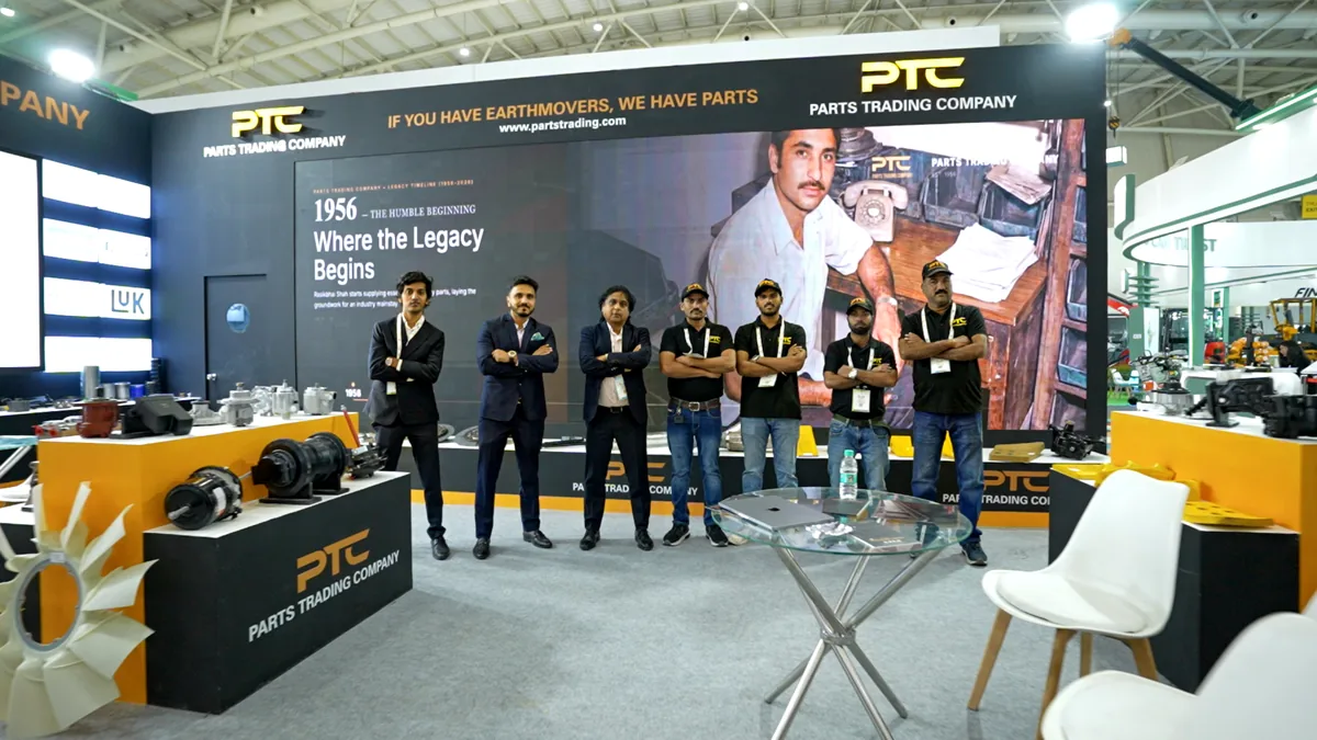 Parts Trading Company team at industry exhibition — Shah family and team with PTC booth displaying heavy equipment spare parts